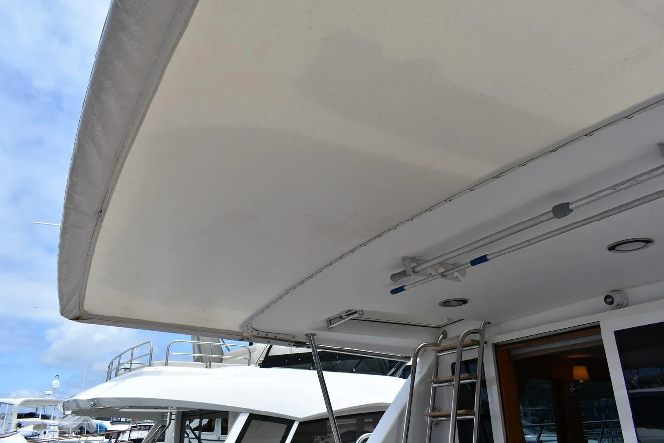 The image captures a detailed view of the yacht's upper deck canopy and surrounding area. aboard 64 OCEAN ALEXANDER Yacht for Sale