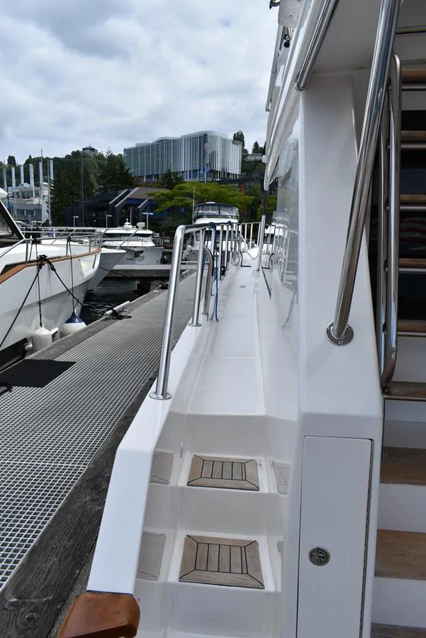 The image showcases the side deck of the yacht, featuring clean lines and sturdy railings. aboard 64 OCEAN ALEXANDER Yacht for Sale