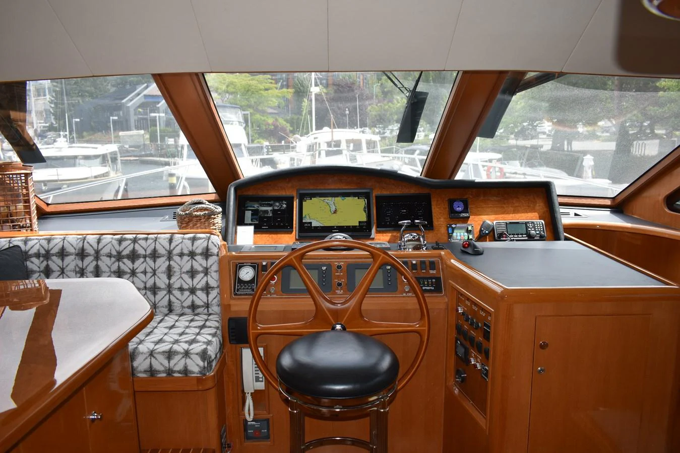The helm station features a sophisticated navigation setup with a comfortable captain's chair and panoramic windows. aboard 64 OCEAN ALEXANDER Yacht for Sale