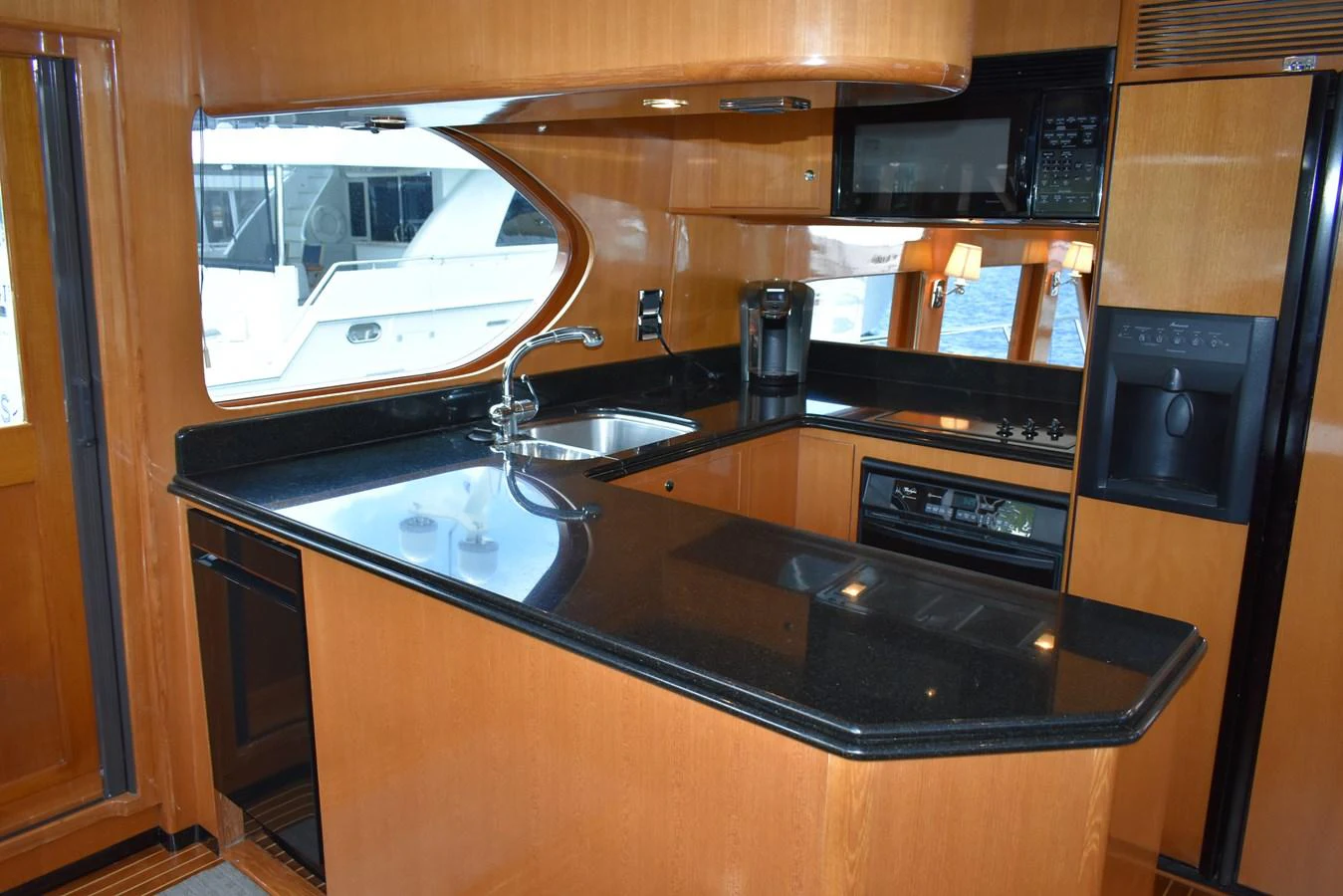 The yacht's galley features sleek black countertops and modern appliances, offering a stylish and functional cooking space. aboard 64 OCEAN ALEXANDER Yacht for Sale