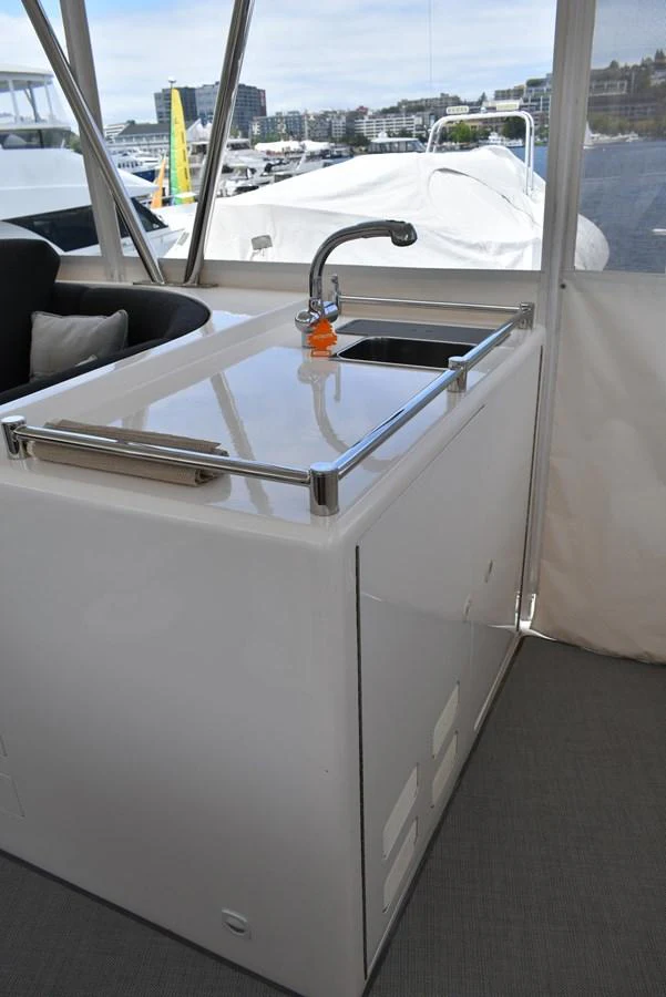 The yacht features a compact galley with a sleek countertop and a built-in sink. aboard 64 OCEAN ALEXANDER Yacht for Sale