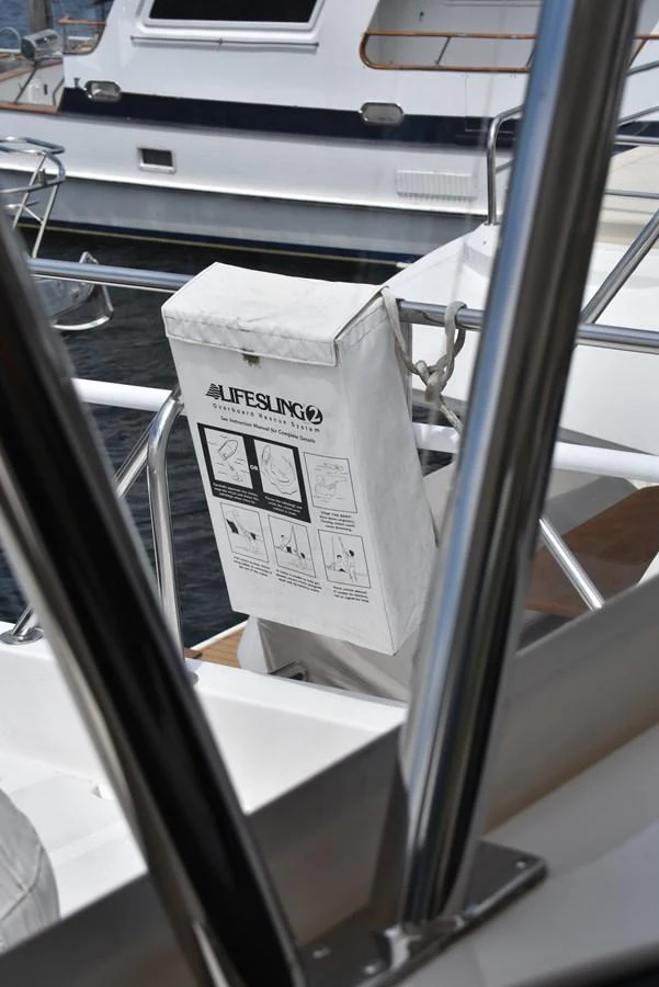 A close-up view of a lifesling safety device mounted on the yacht's railing. aboard 64 OCEAN ALEXANDER Yacht for Sale