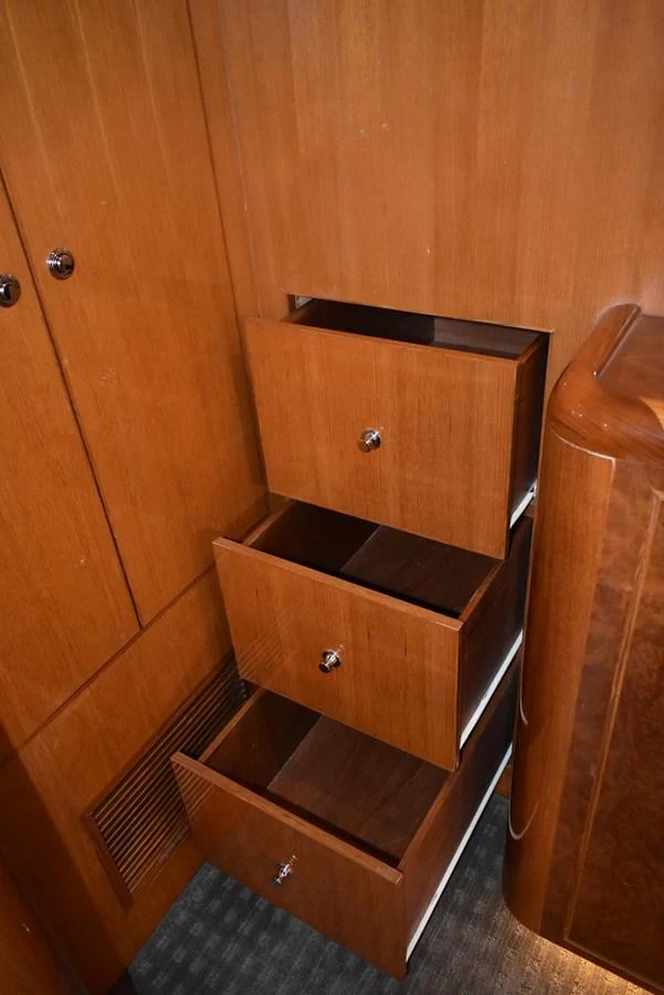 The image showcases a set of wooden drawers in a yacht's interior. aboard 64 OCEAN ALEXANDER Yacht for Sale