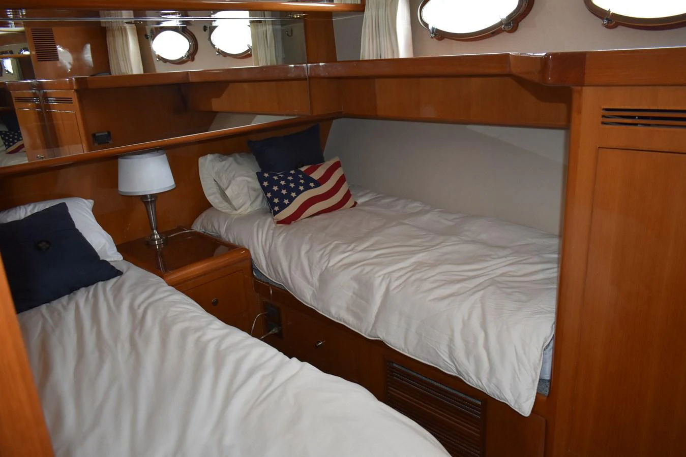 The guest cabin features twin beds with a cozy and inviting atmosphere. aboard 64 OCEAN ALEXANDER Yacht for Sale