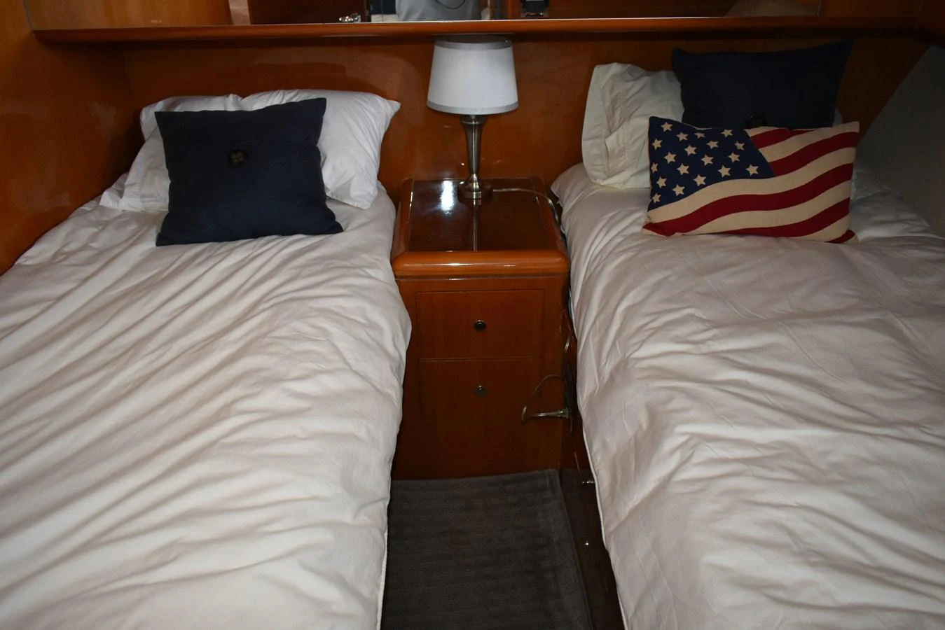 The twin stateroom features two comfortable beds with plush bedding and a cozy ambiance. aboard 64 OCEAN ALEXANDER Yacht for Sale