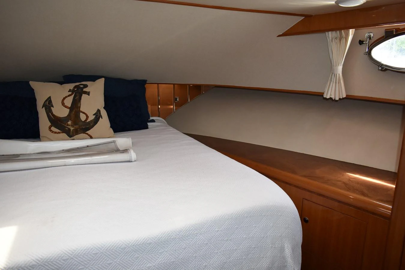 A cozy stateroom featuring a comfortable bed with nautical-themed decor. aboard 64 OCEAN ALEXANDER Yacht for Sale