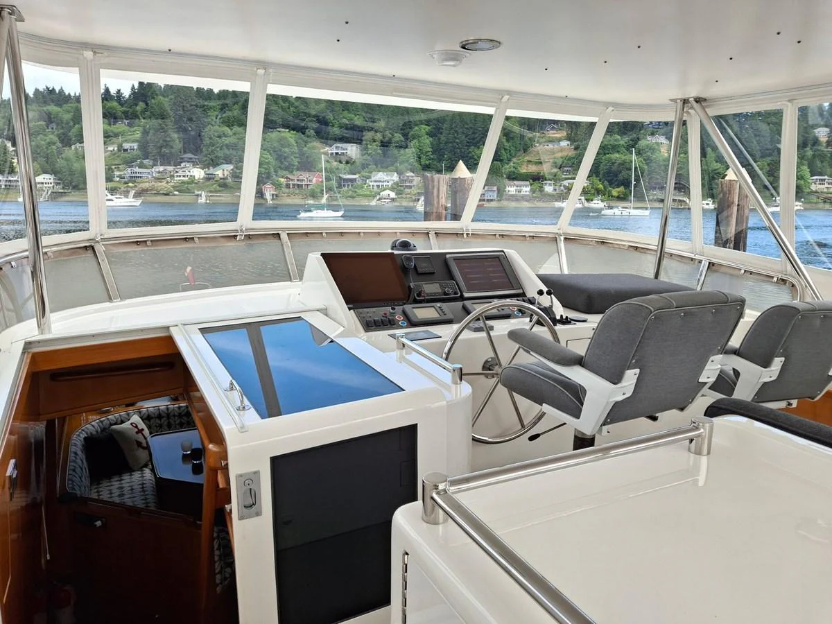 The helm station offers a panoramic view with modern navigation equipment and comfortable seating. aboard 64 OCEAN ALEXANDER Yacht for Sale