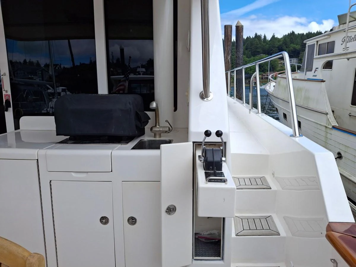 The yacht features a well-equipped outdoor area with a grill and control station, perfect for alfresco dining and easy maneuvering. aboard 64 OCEAN ALEXANDER Yacht for Sale