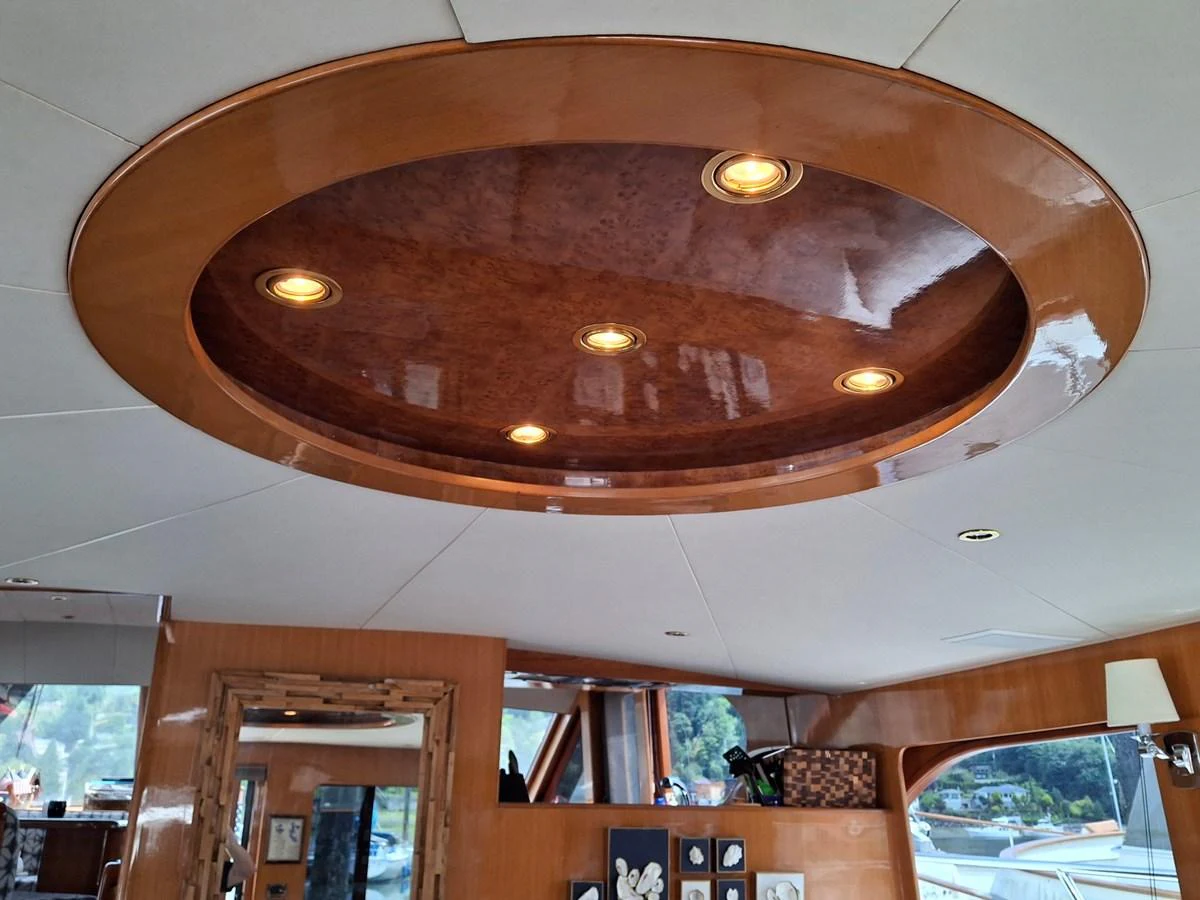 The image showcases a luxurious yacht interior with a polished wooden ceiling feature and recessed lighting. aboard 64 OCEAN ALEXANDER Yacht for Sale