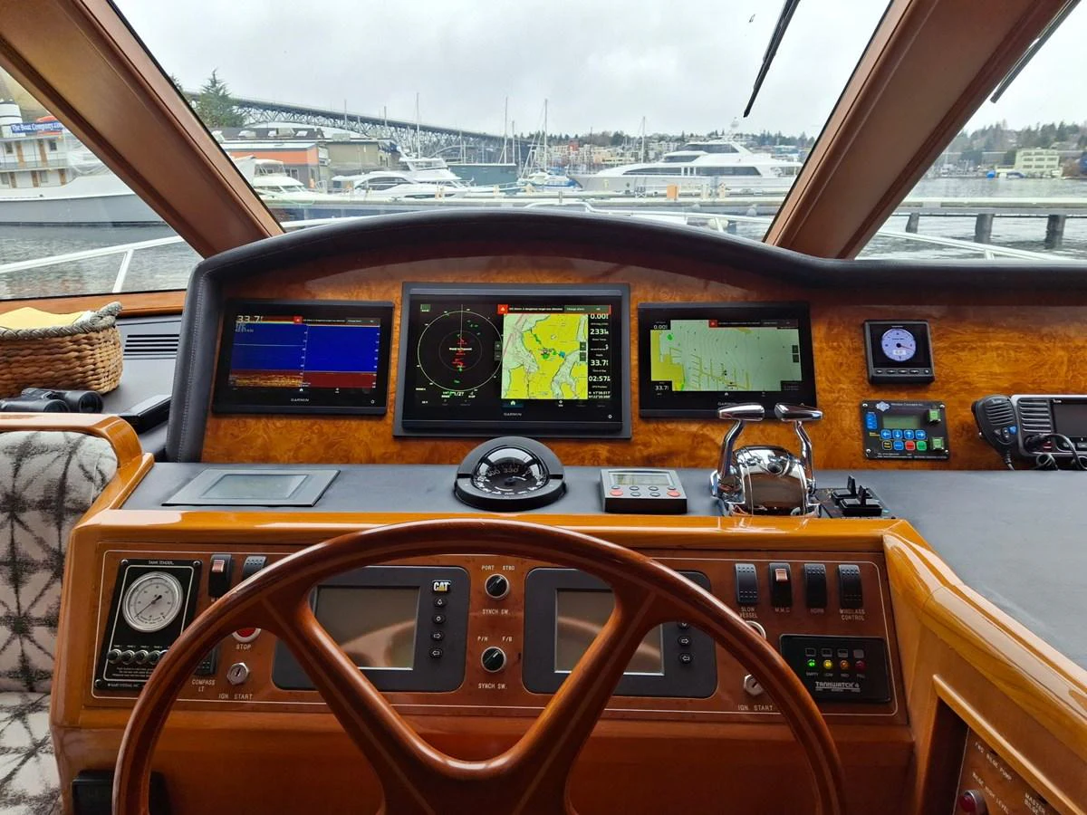 The helm station features advanced navigation equipment and a panoramic view of the marina. aboard 64 OCEAN ALEXANDER Yacht for Sale