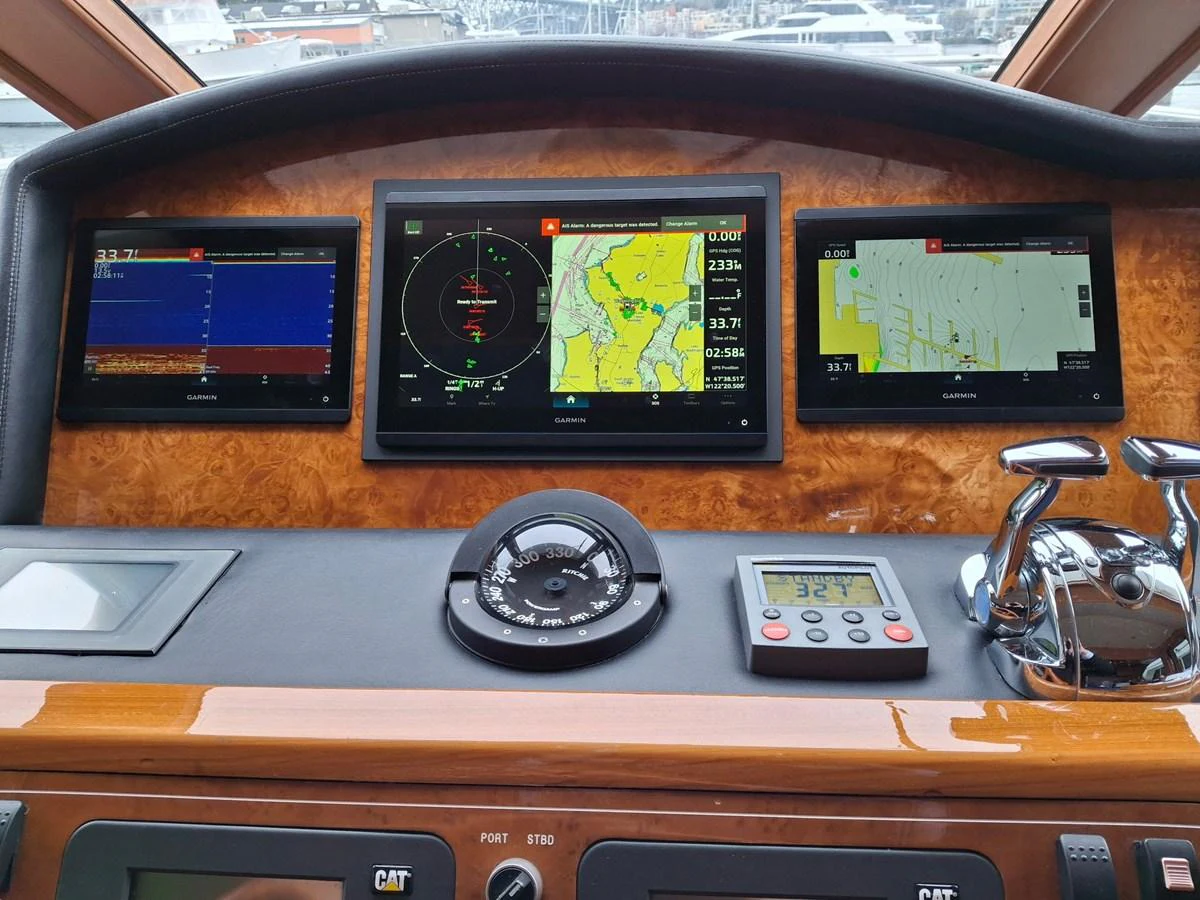 The helm station features advanced navigation and control systems with multiple displays. aboard 64 OCEAN ALEXANDER Yacht for Sale