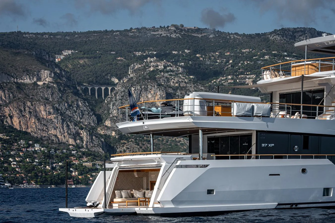 The yacht's aft deck offers a luxurious lounging area with scenic views of the coastline. aboard NUMARINE 37XP#22 Yacht for Sale