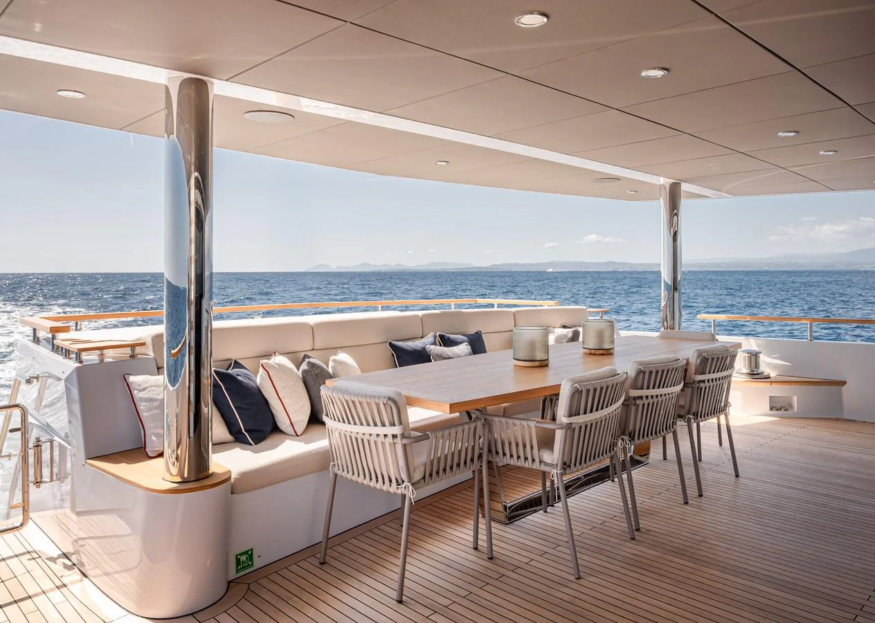 The aft deck features a spacious dining area with a stunning ocean view. aboard NUMARINE 37XP#22 Yacht for Sale