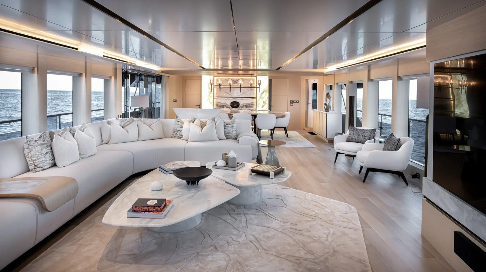 The spacious salon features elegant furnishings and panoramic windows offering stunning ocean views. aboard NUMARINE 37XP#22 Yacht for Sale