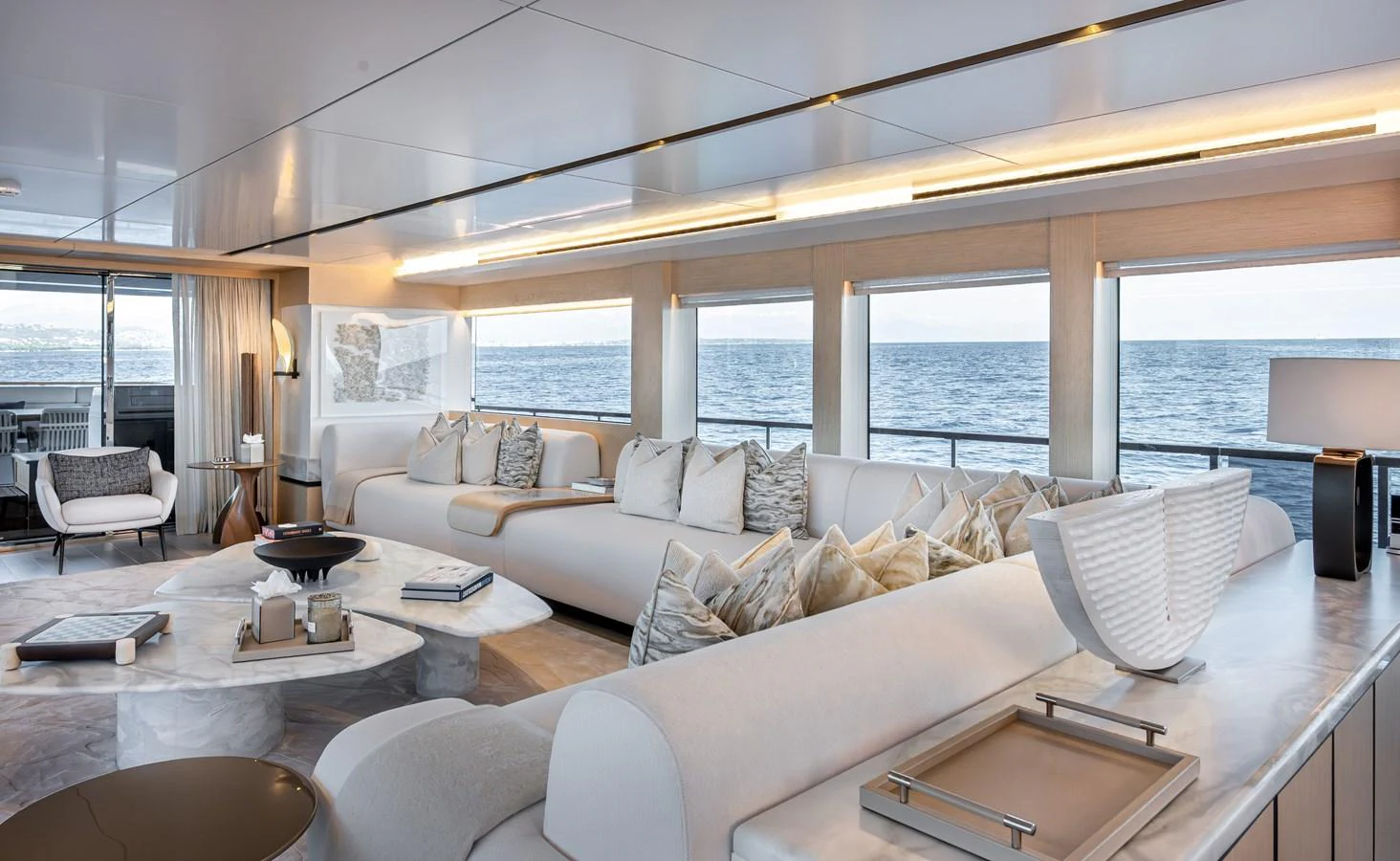 The yacht's salon features elegant, modern furnishings with panoramic ocean views. aboard NUMARINE 37XP#22 Yacht for Sale