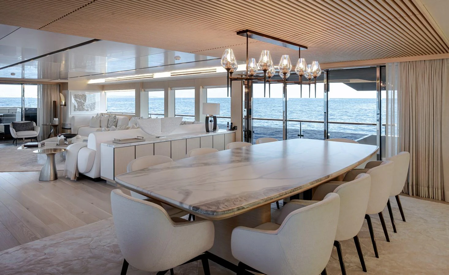 The yacht's dining area features a luxurious table with elegant seating and expansive ocean views. aboard NUMARINE 37XP#22 Yacht for Sale