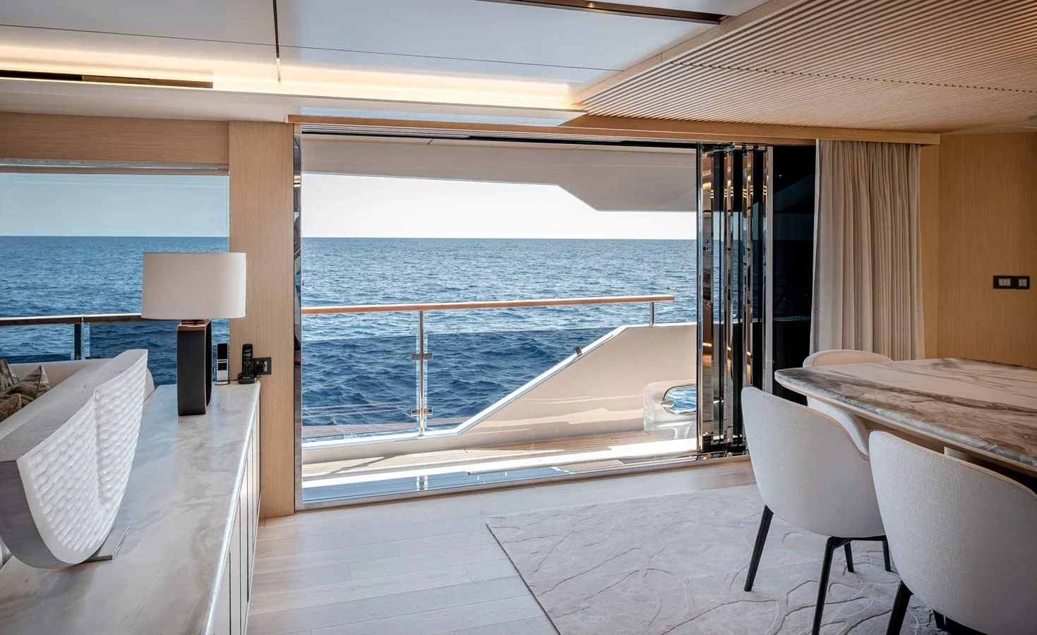 A luxurious yacht interior with an open view to the sea, featuring elegant furnishings and a serene ambiance. aboard NUMARINE 37XP#22 Yacht for Sale