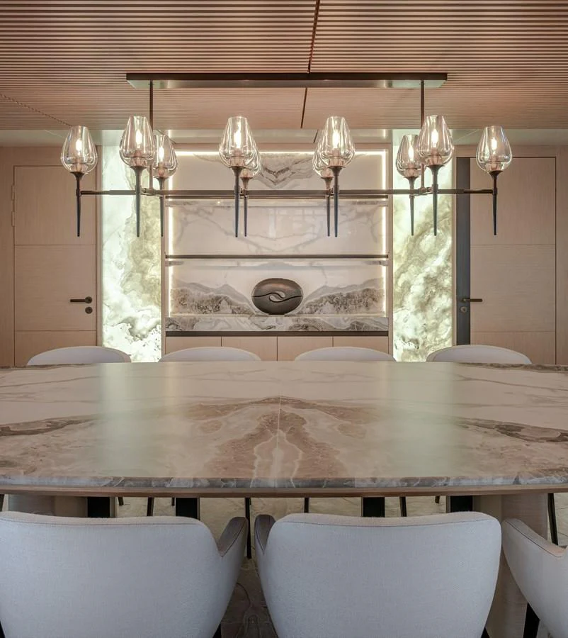 The yacht's dining area features a luxurious marble table and elegant lighting fixtures, creating a sophisticated ambiance. aboard NUMARINE 37XP#22 Yacht for Sale