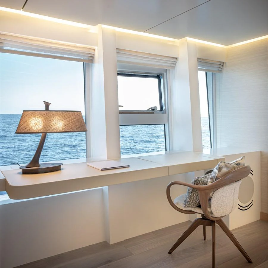 A serene office space with a view of the ocean, featuring modern furnishings and ample natural light. aboard NUMARINE 37XP#22 Yacht for Sale