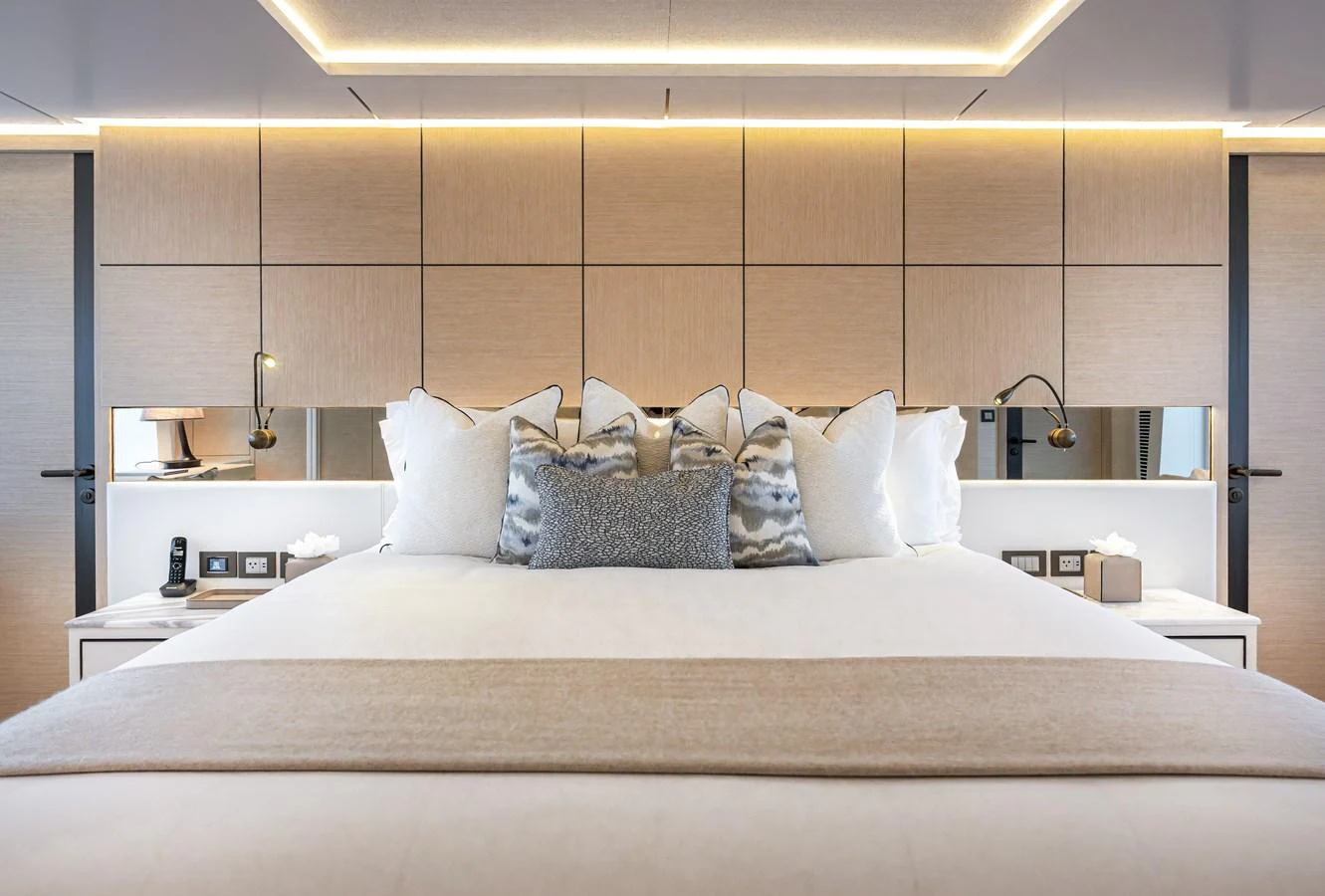 The master stateroom features a luxurious bed with plush pillows and modern lighting. aboard NUMARINE 37XP#22 Yacht for Sale