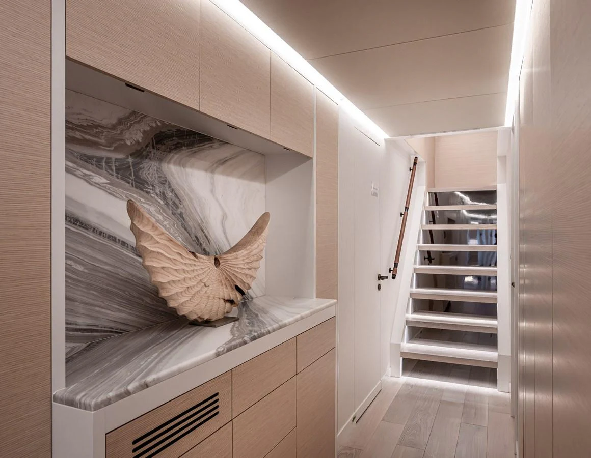 The yacht's interior features a stylish hallway with modern decor and a striking marble accent. aboard NUMARINE 37XP#22 Yacht for Sale