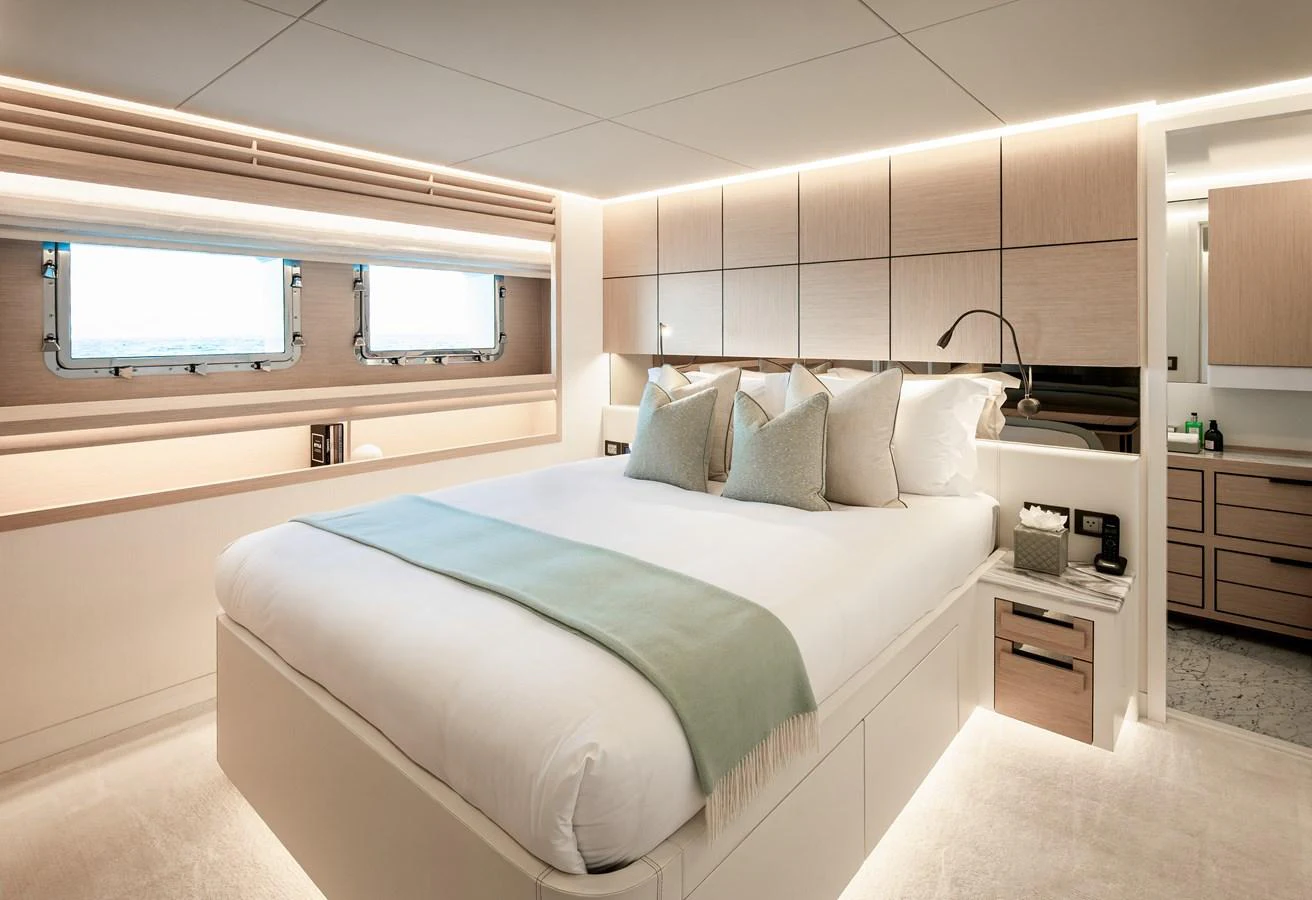 A luxurious stateroom featuring a large bed with elegant bedding and ample natural light. aboard NUMARINE 37XP#22 Yacht for Sale