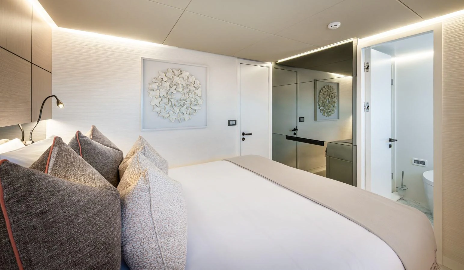 The stateroom features a plush bed with elegant decor and modern lighting. aboard NUMARINE 37XP#22 Yacht for Sale