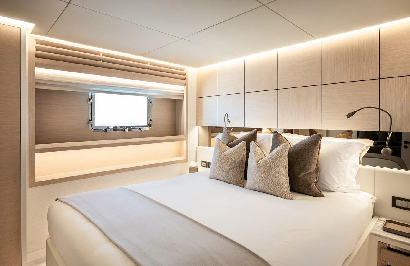 A luxurious stateroom featuring a large bed with plush pillows and modern lighting. aboard NUMARINE 37XP#22 Yacht for Sale