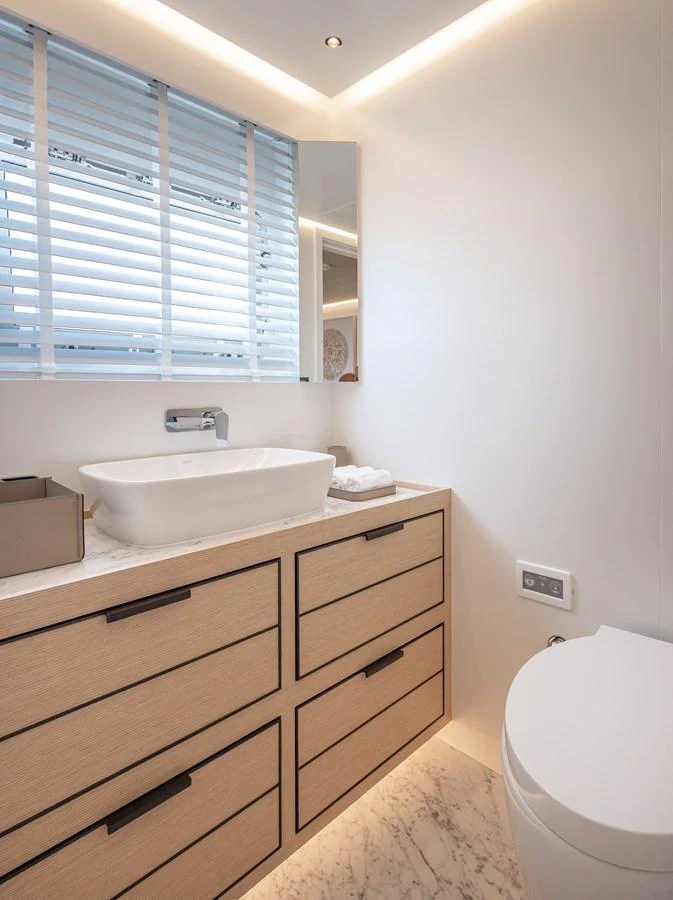 A modern yacht bathroom featuring sleek fixtures and ample storage space. aboard NUMARINE 37XP#22 Yacht for Sale