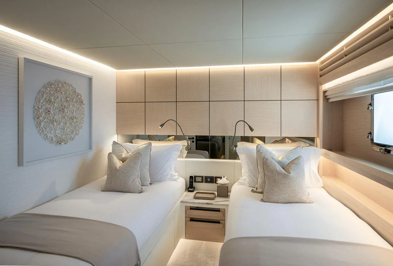 The guest stateroom features twin beds with elegant bedding and modern lighting. aboard NUMARINE 37XP#22 Yacht for Sale