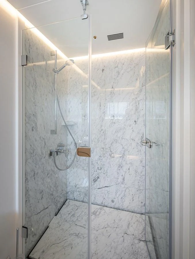The yacht's bathroom features a luxurious marble shower with modern fixtures. aboard NUMARINE 37XP#22 Yacht for Sale