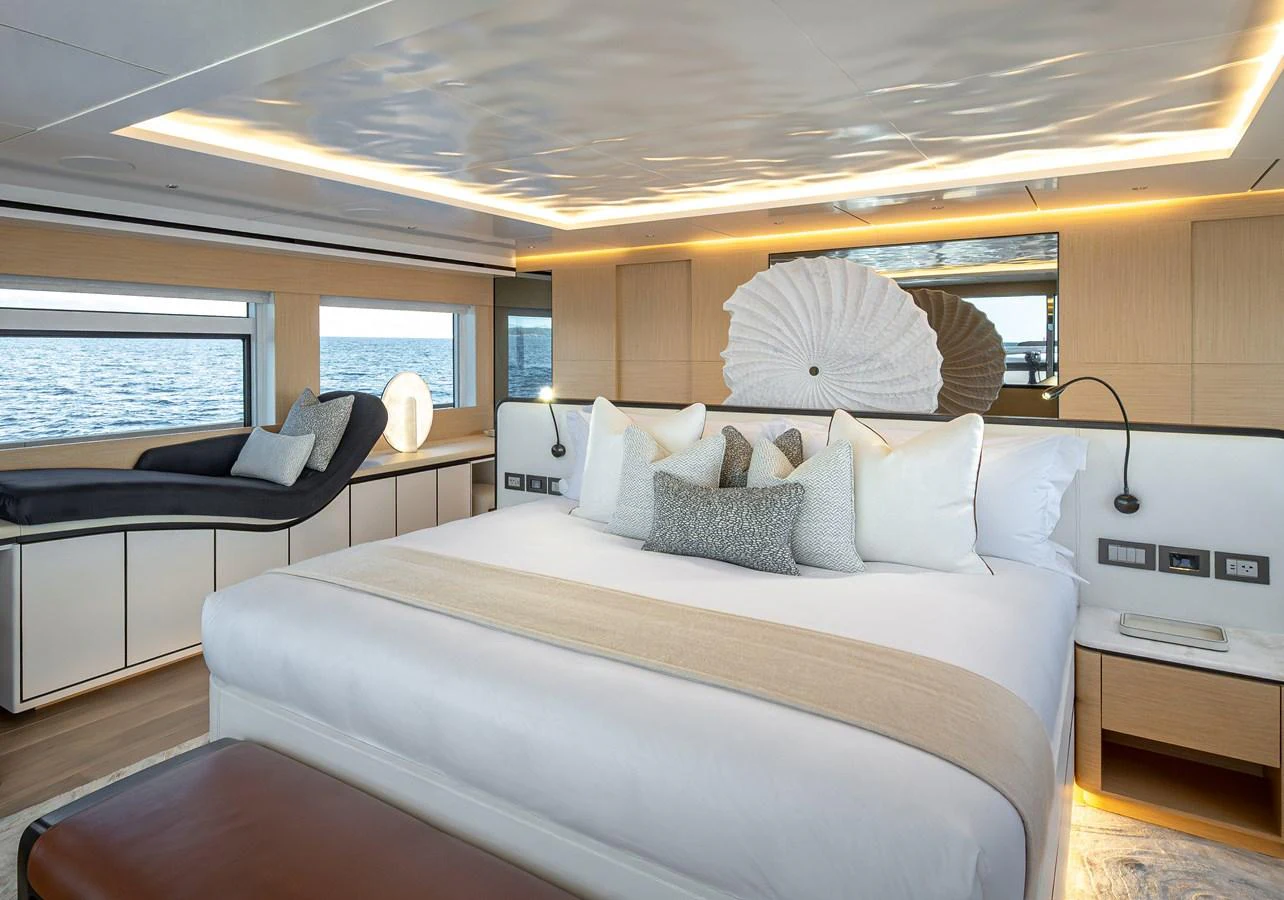 The master stateroom features a luxurious bed with elegant decor and panoramic windows offering stunning sea views. aboard NUMARINE 37XP#22 Yacht for Sale