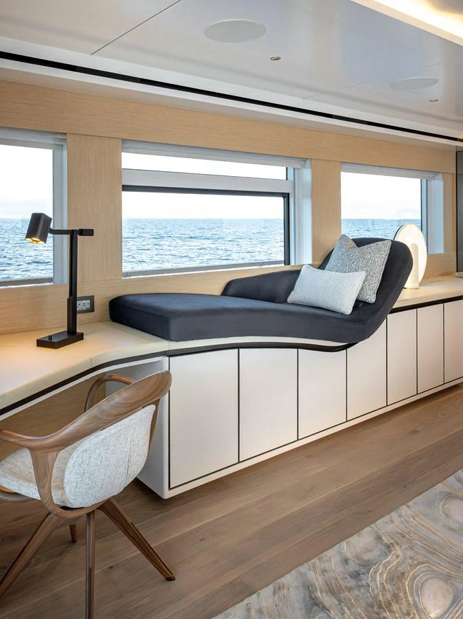 A serene interior space featuring a stylish lounge area with a view of the sea. aboard NUMARINE 37XP#22 Yacht for Sale