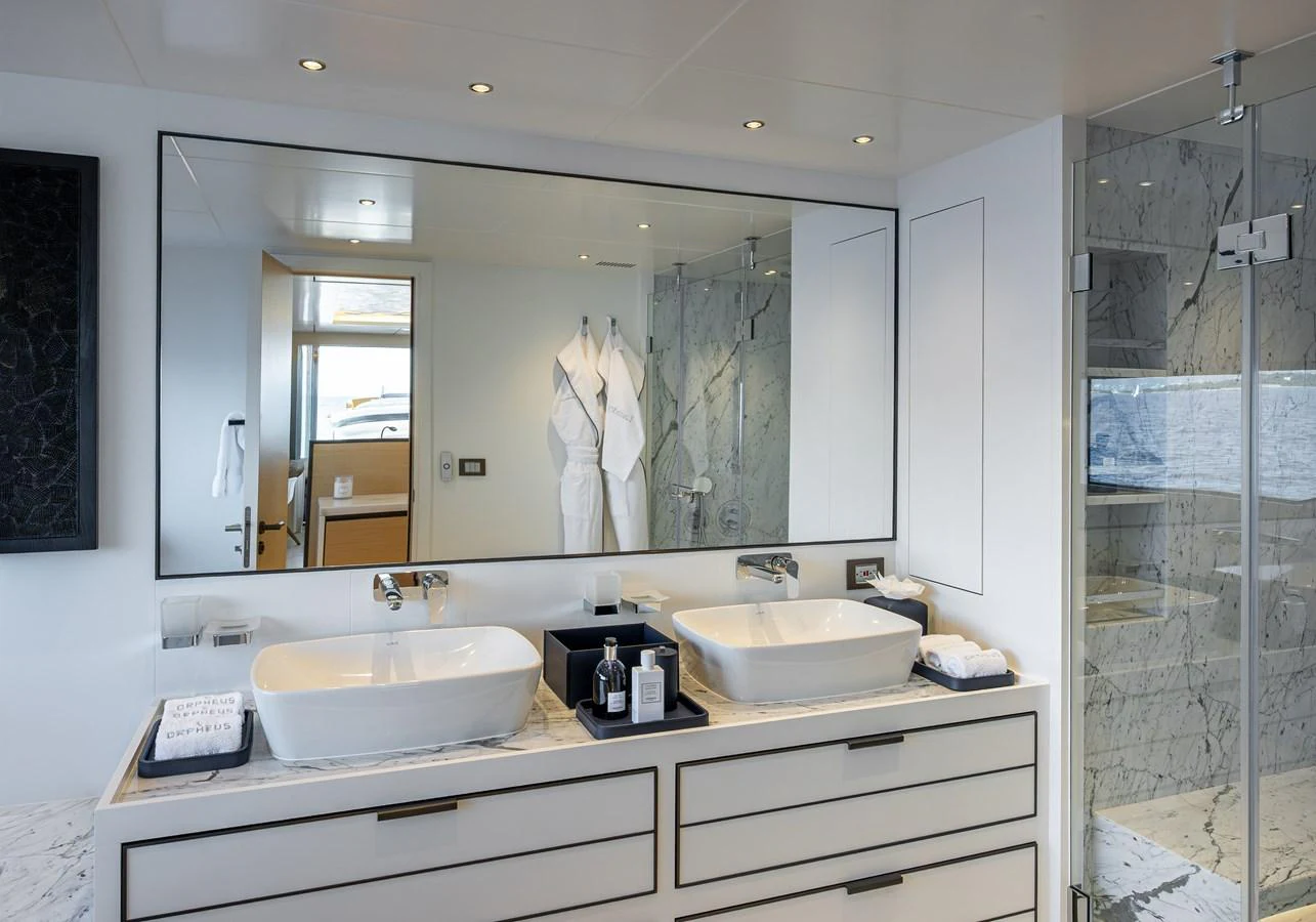 The luxurious bathroom features dual sinks, a large mirror, and a spacious glass-enclosed shower. aboard NUMARINE 37XP#22 Yacht for Sale