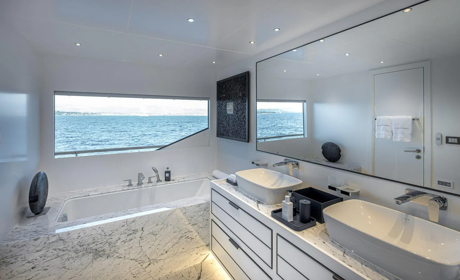 A luxurious yacht bathroom with a marble countertop and a stunning ocean view. aboard NUMARINE 37XP#22 Yacht for Sale