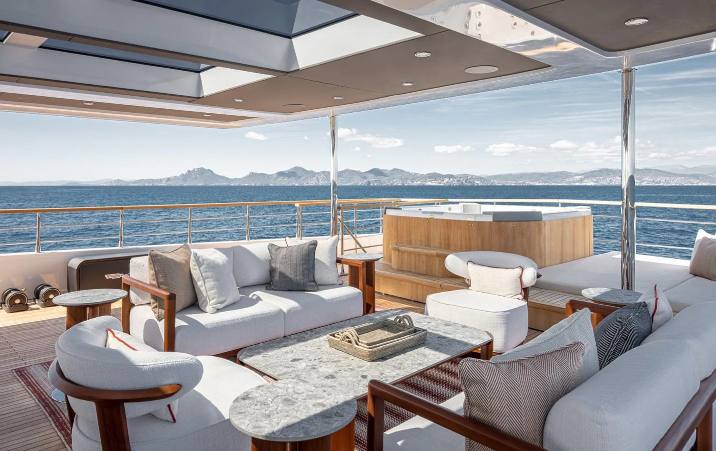 The aft deck features a luxurious seating area with a stunning ocean view and a jacuzzi. aboard NUMARINE 37XP#22 Yacht for Sale