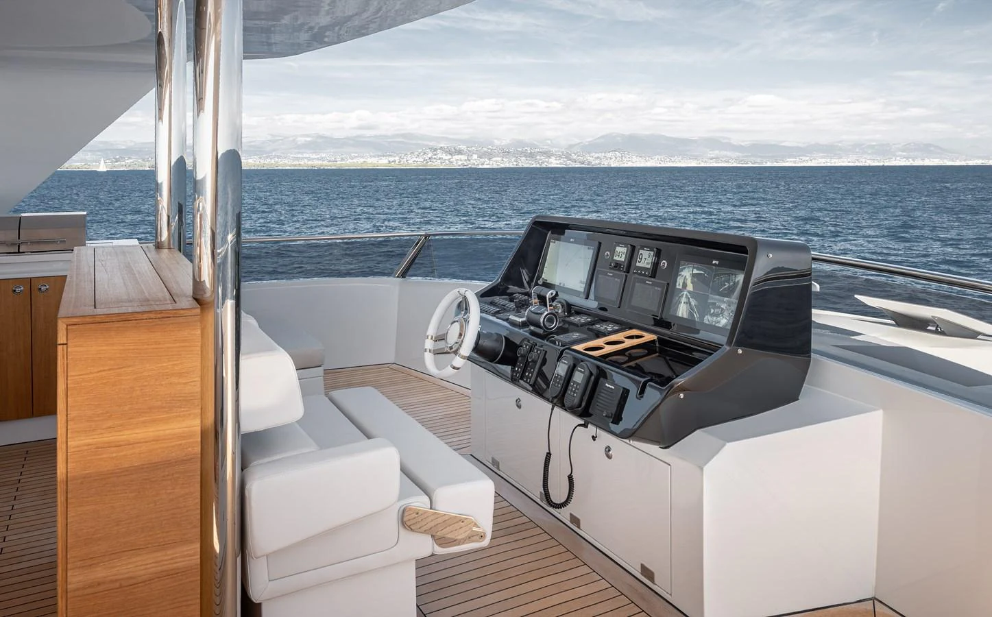 The yacht's helm features modern navigation equipment and a comfortable seating area with a stunning ocean view. aboard NUMARINE 37XP#22 Yacht for Sale