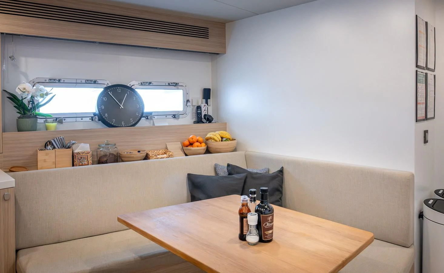 The cozy dining area features a wooden table and comfortable seating with a view through the porthole. aboard NUMARINE 37XP#22 Yacht for Sale