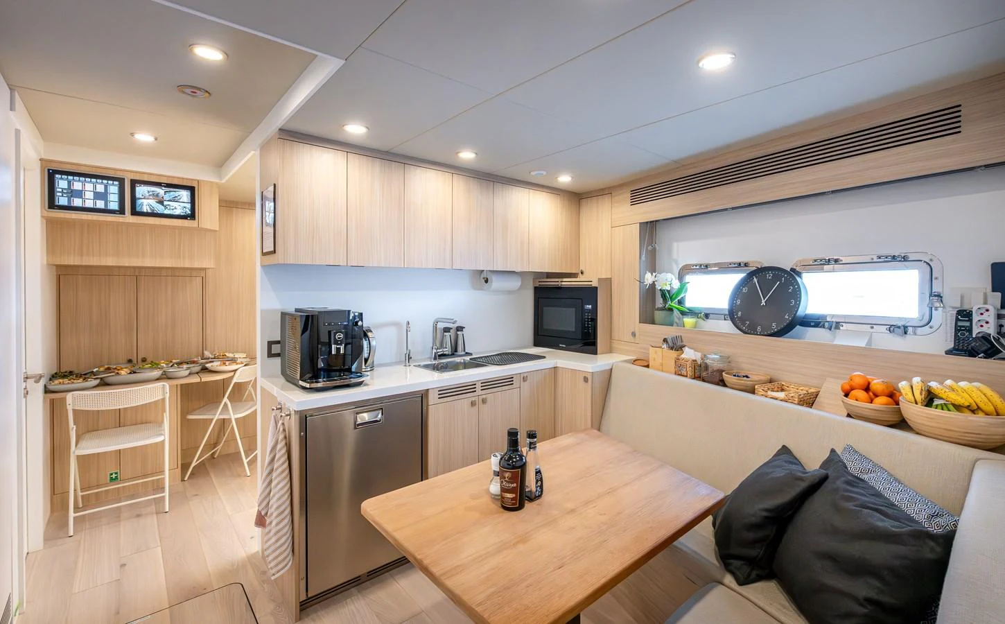 The yacht's galley features modern appliances, a cozy dining area, and ample natural light. aboard NUMARINE 37XP#22 Yacht for Sale