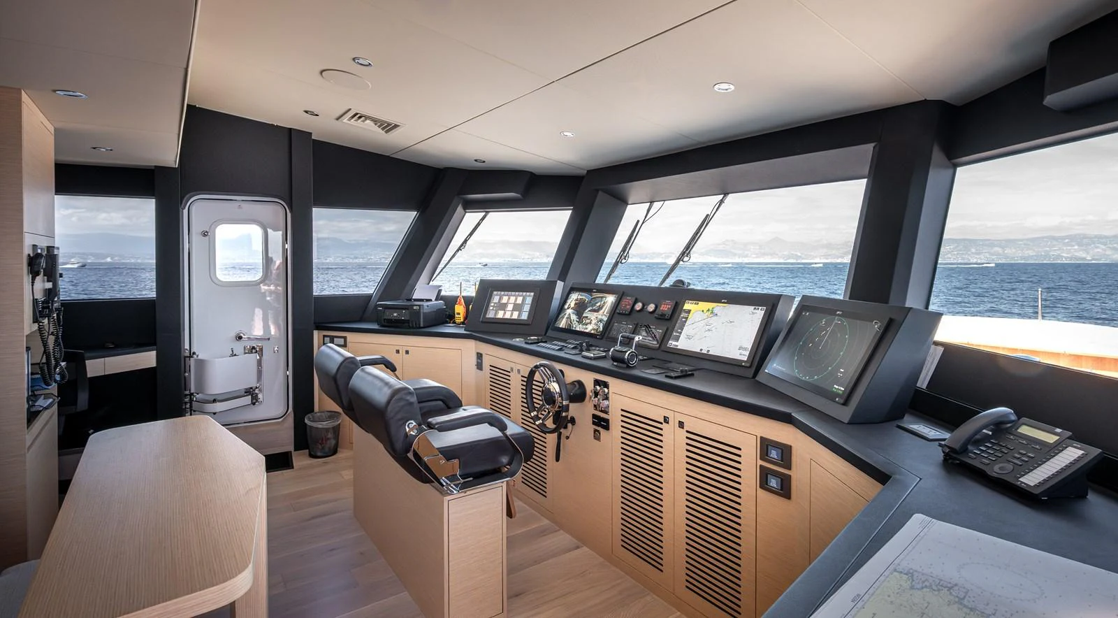 The helm of the yacht features state-of-the-art navigation equipment and panoramic windows for optimal visibility. aboard NUMARINE 37XP#22 Yacht for Sale