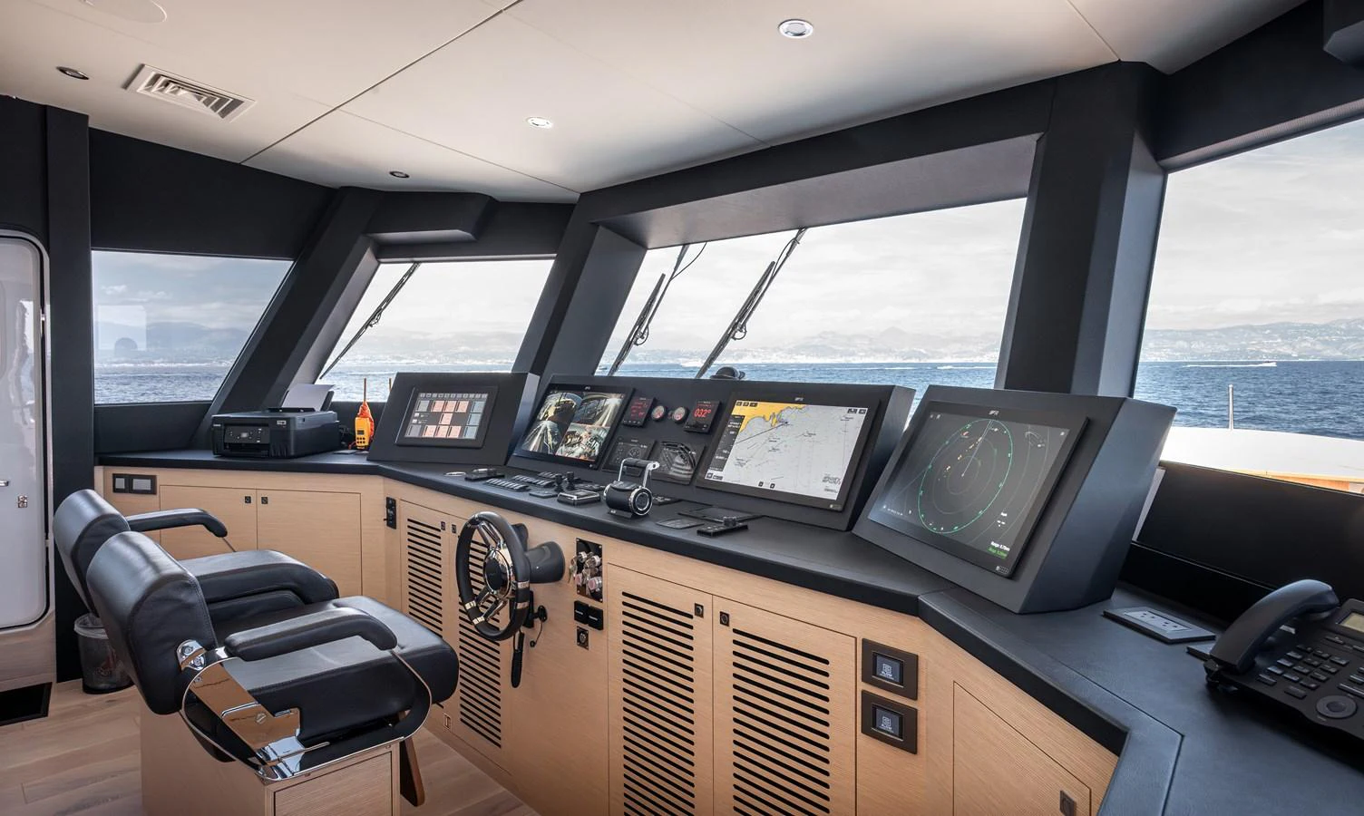 The helm station features state-of-the-art navigation and control systems with panoramic views. aboard NUMARINE 37XP#22 Yacht for Sale