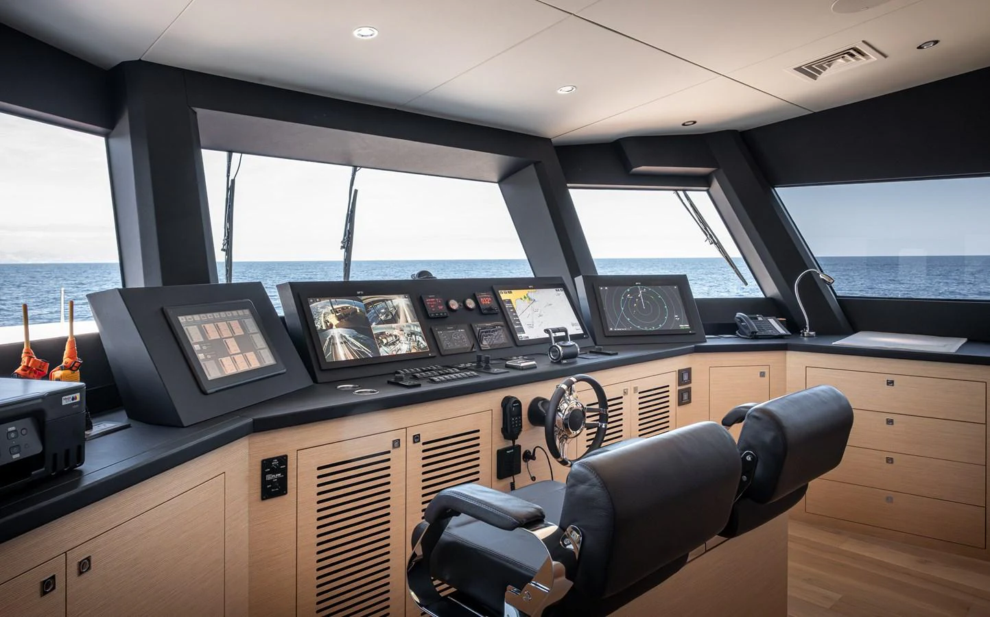 The helm station offers a sophisticated and modern control area with panoramic views of the sea. aboard NUMARINE 37XP#22 Yacht for Sale