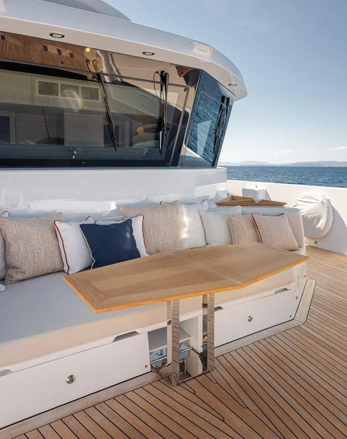 The aft deck features a comfortable seating area with a wooden table, perfect for outdoor relaxation. aboard NUMARINE 37XP#22 Yacht for Sale