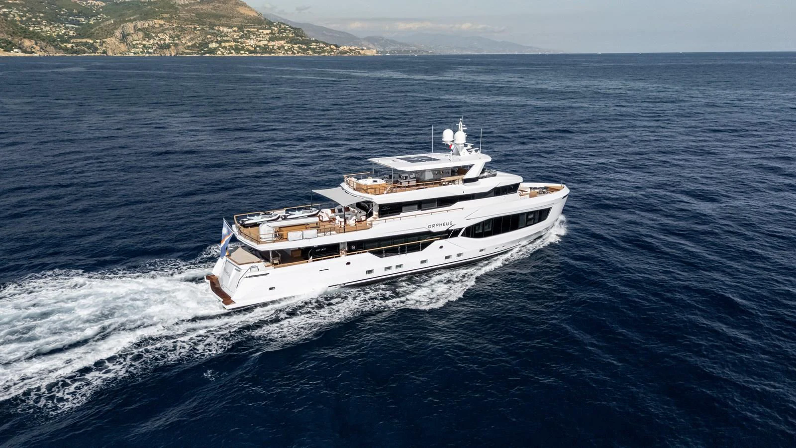 A luxurious yacht cruises through the open sea, showcasing its elegant design and spacious decks. aboard NUMARINE 37XP#22 Yacht for Sale