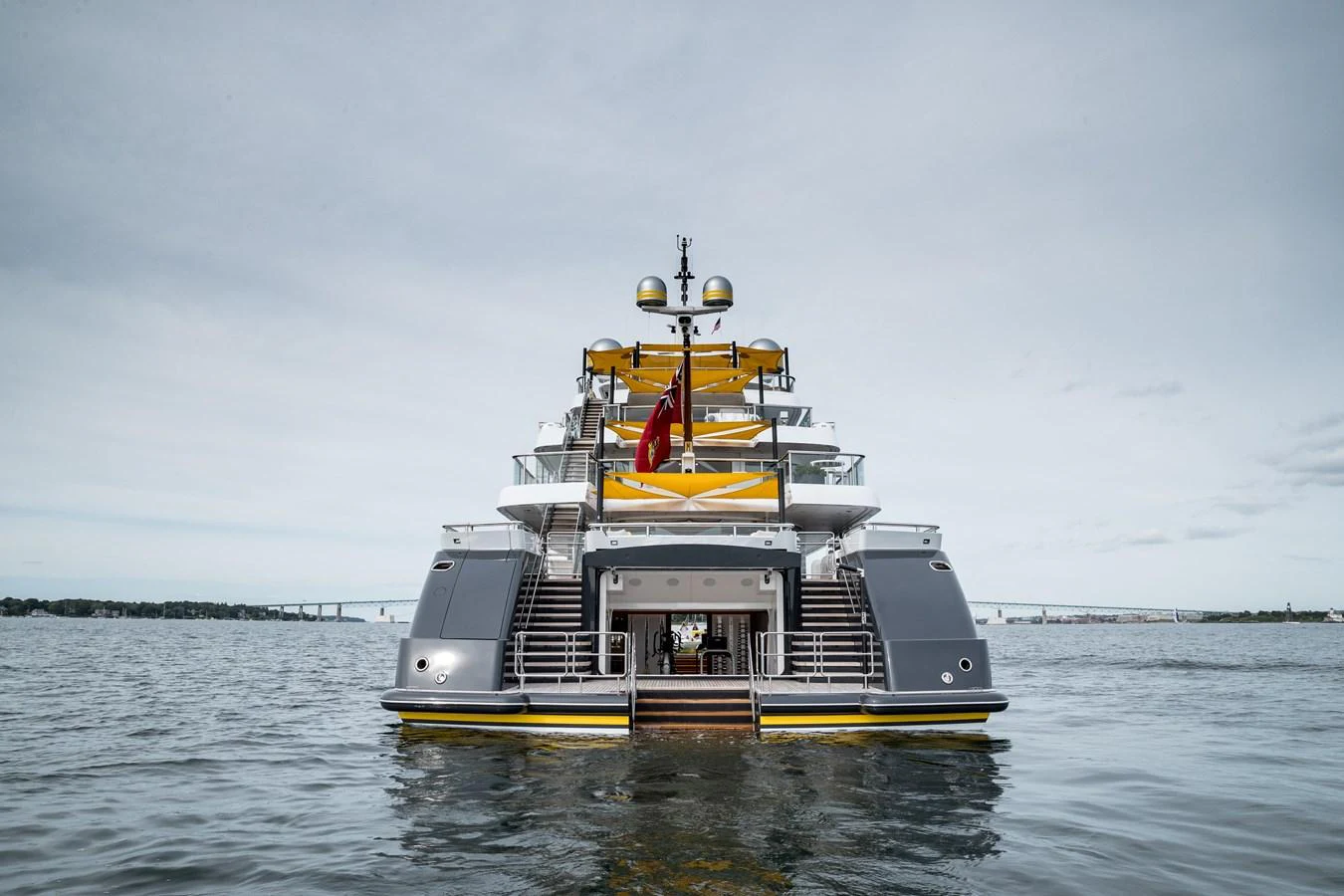 A luxurious yacht is anchored on calm waters, showcasing its multi-level design and modern amenities. aboard SCOUT Yacht for Sale