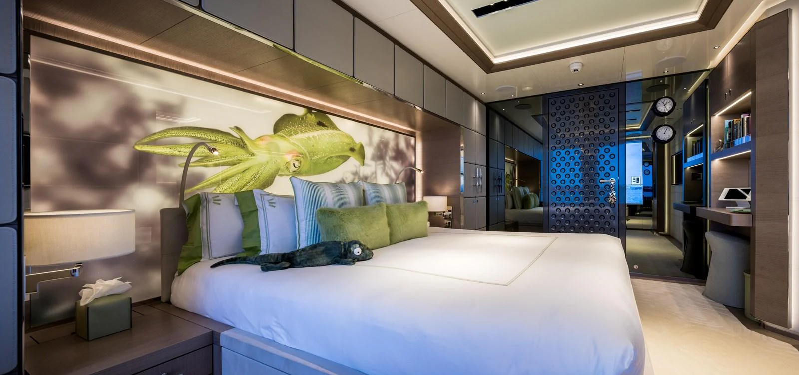 A luxurious stateroom featuring a large bed with elegant decor and ambient lighting. aboard SCOUT Yacht for Sale