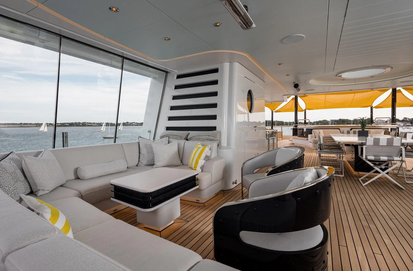 The aft deck features a spacious seating area with plush cushions and a dining table, perfect for relaxing and entertaining. aboard SCOUT Yacht for Sale