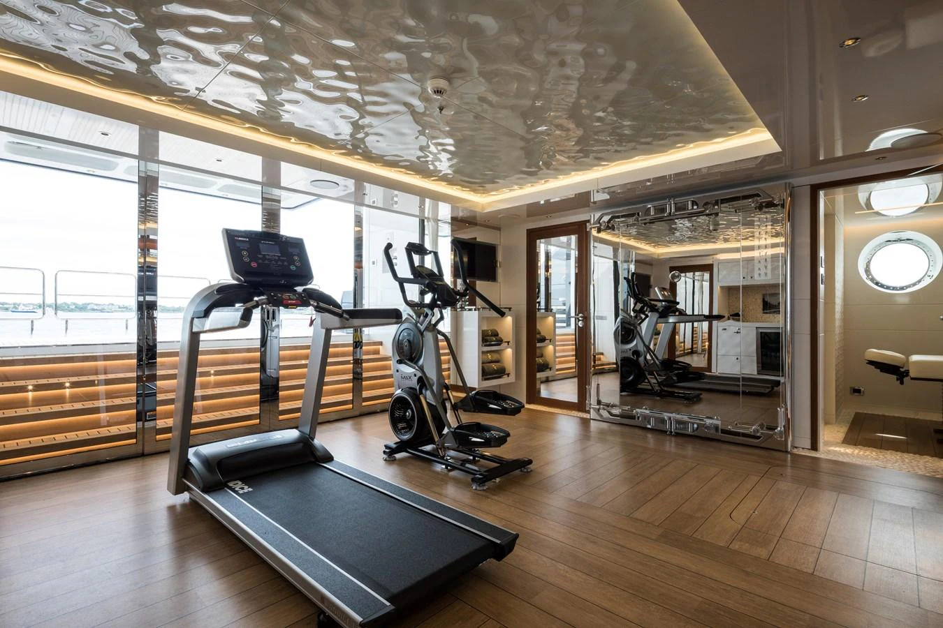 The yacht features a well-equipped gym with modern fitness equipment and a view of the sea. aboard SCOUT Yacht for Sale