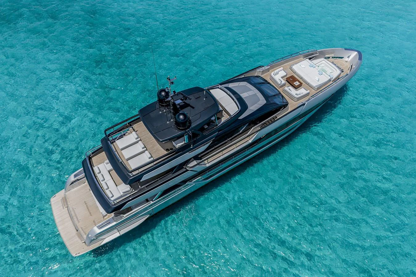 A sleek and modern yacht glides gracefully over crystal-clear turquoise waters. aboard RIVA 130/02 Yacht for Sale