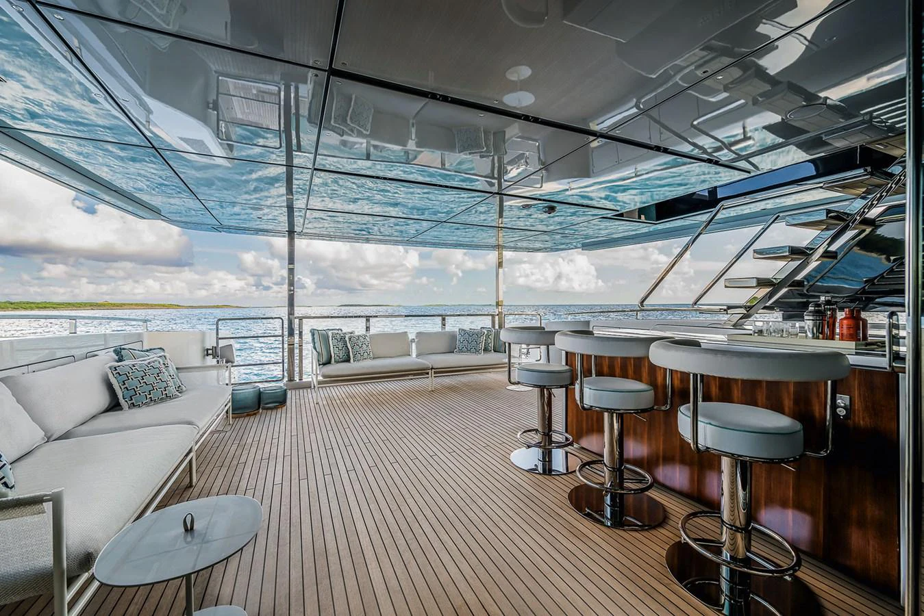 The aft deck features a spacious seating area and a stylish bar with a stunning view of the water. aboard RIVA 130/02 Yacht for Sale
